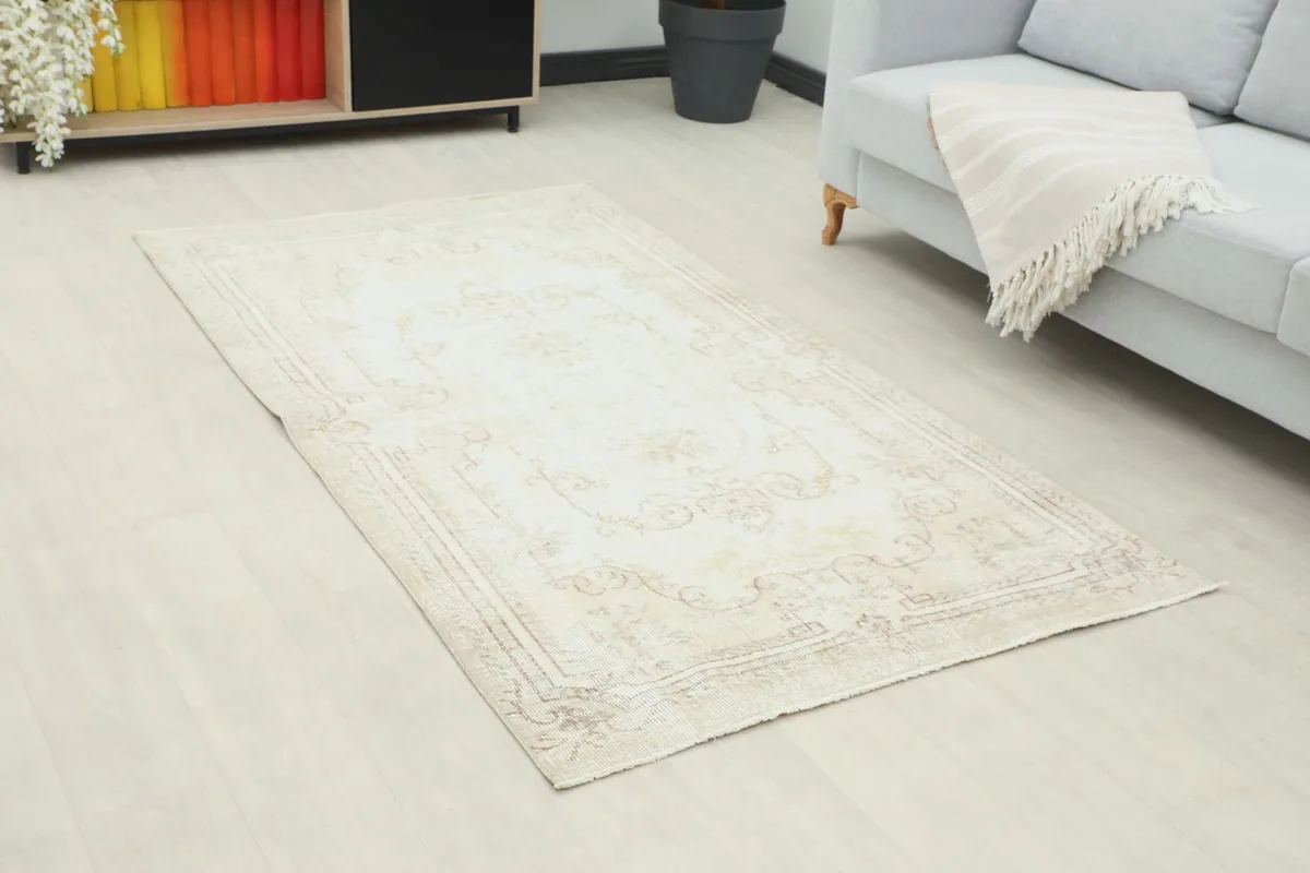 Angle view of the beige rug in a room, highlighting its proportion to furniture