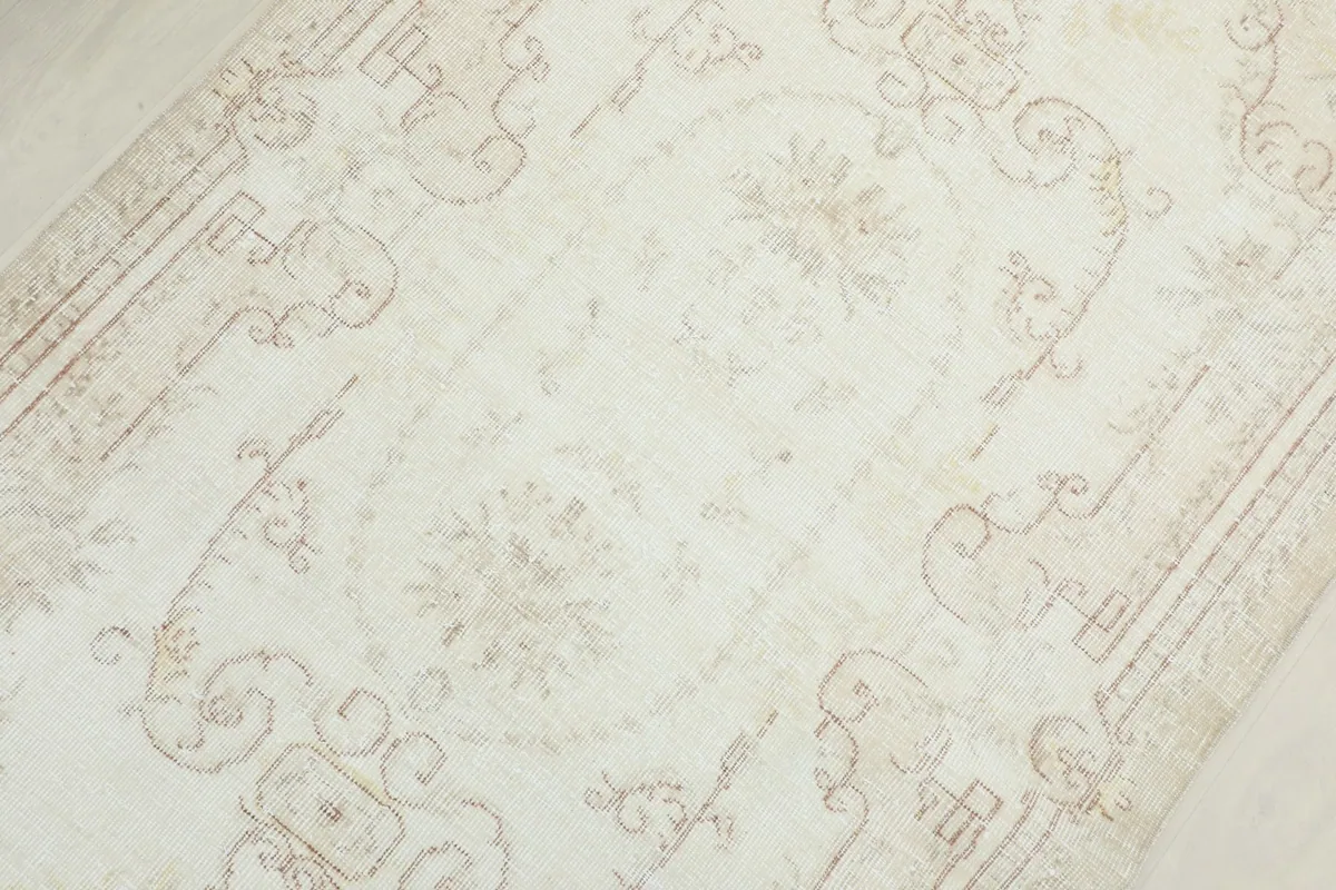 Detailed view of the central medallion and surrounding floral patterns on the rug