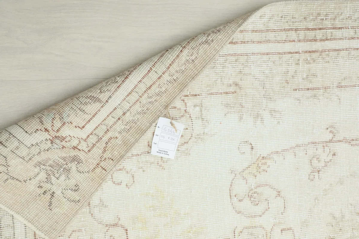 Underside of the rug showing the cotton foundation and hand-knotted construction