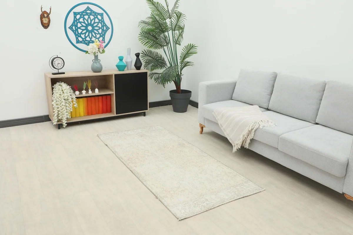 Ivory runner rug in a modern living space with a gray sofa and light wood floor
