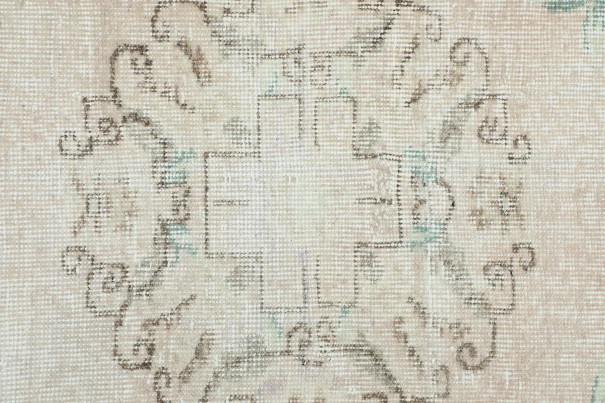 Close-up of the central medallion showing the intricate pattern and texture of the low wool pile.