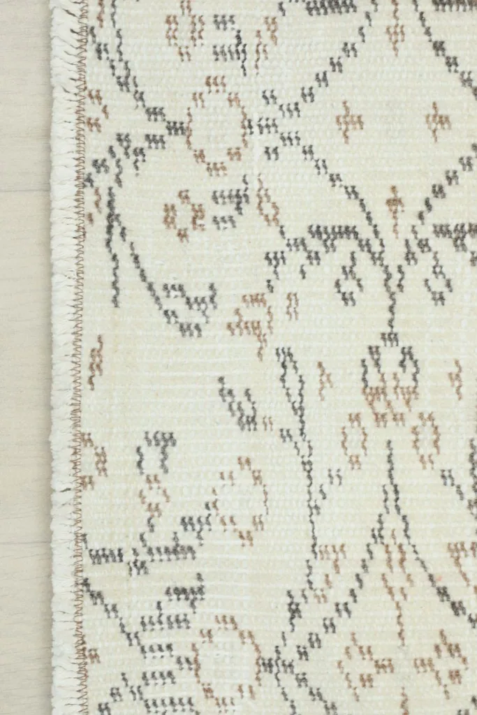 Detail of the short, natural fringe and the finished edge of the vintage runner rug.