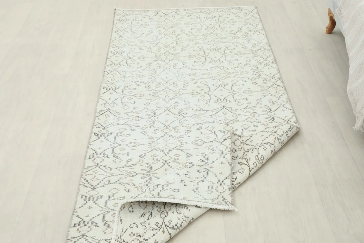 The rug partially folded, showing its flexibility and the consistent pattern from top to bottom.