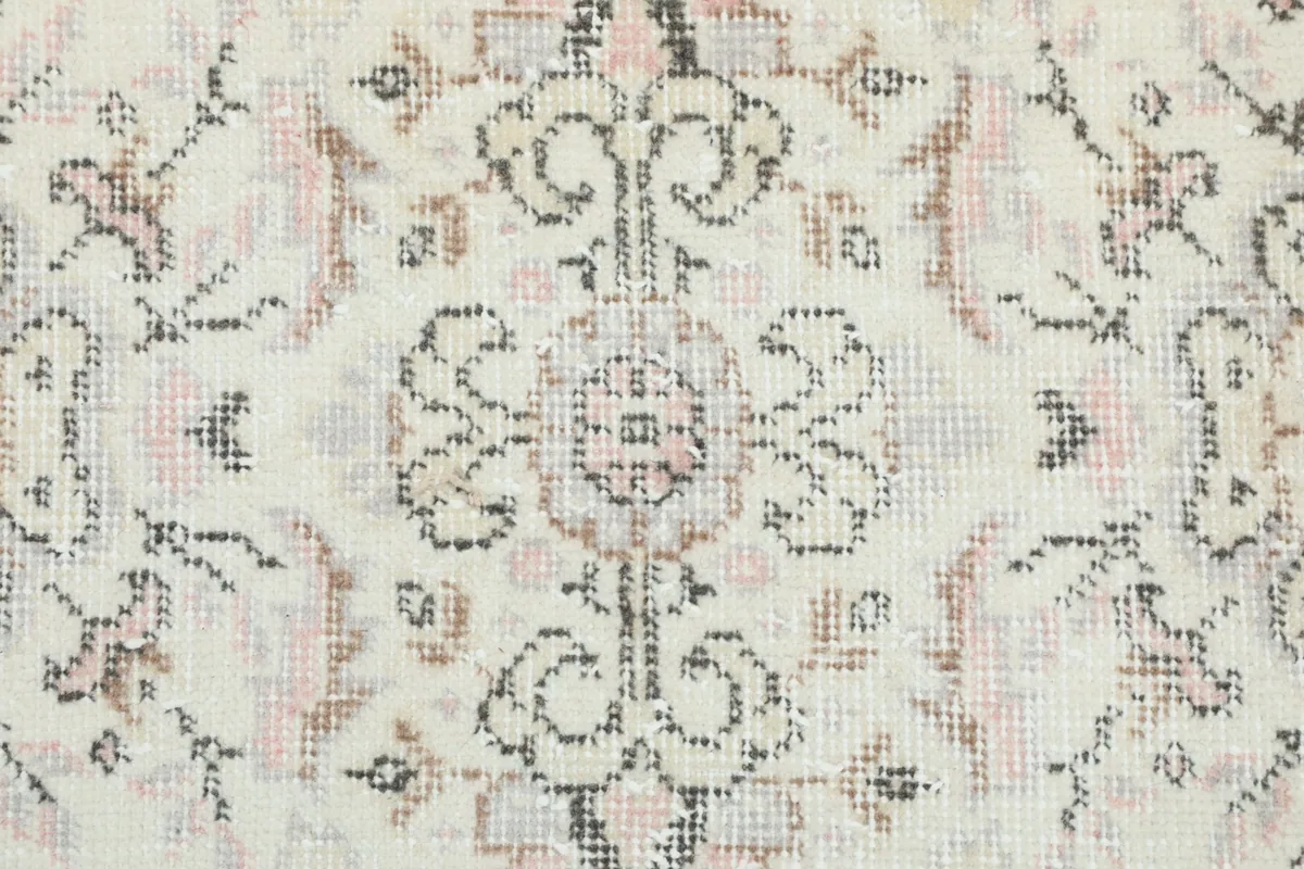 Close-up of the hand-knotted wool pile and intricate floral medallion motifs