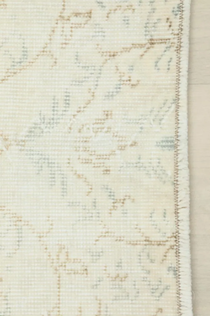 Close-up of the side edge and a portion of the main pattern, revealing the binding.