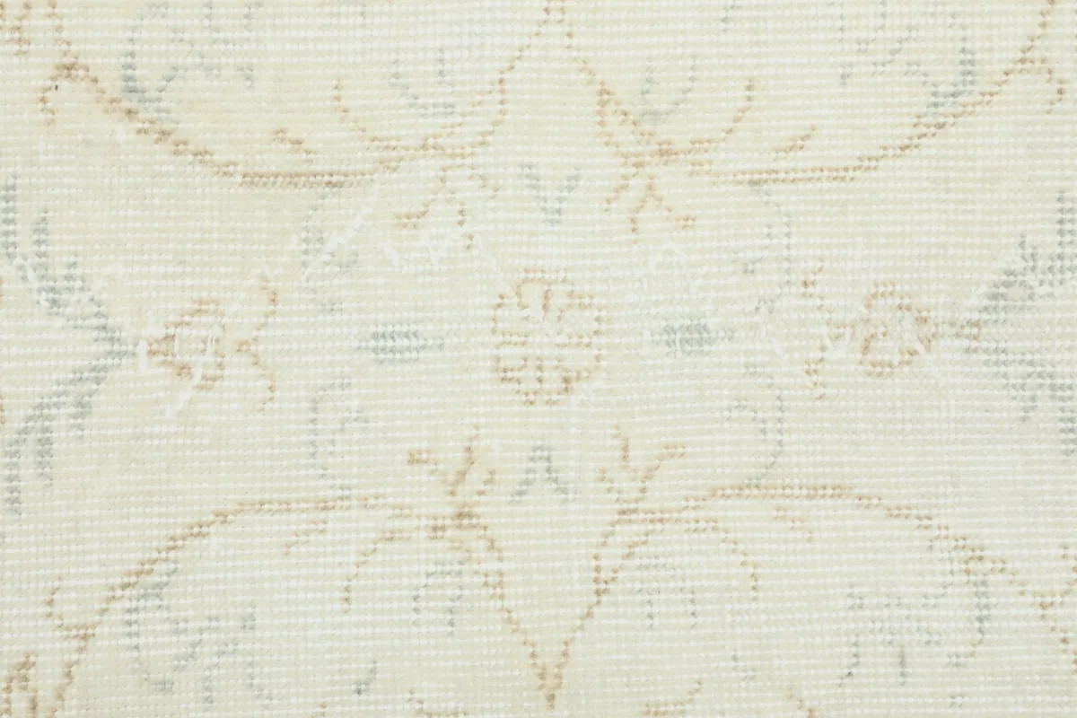 Detailed close-up of the low wool pile, showing the hand-knotted texture and faded colors.