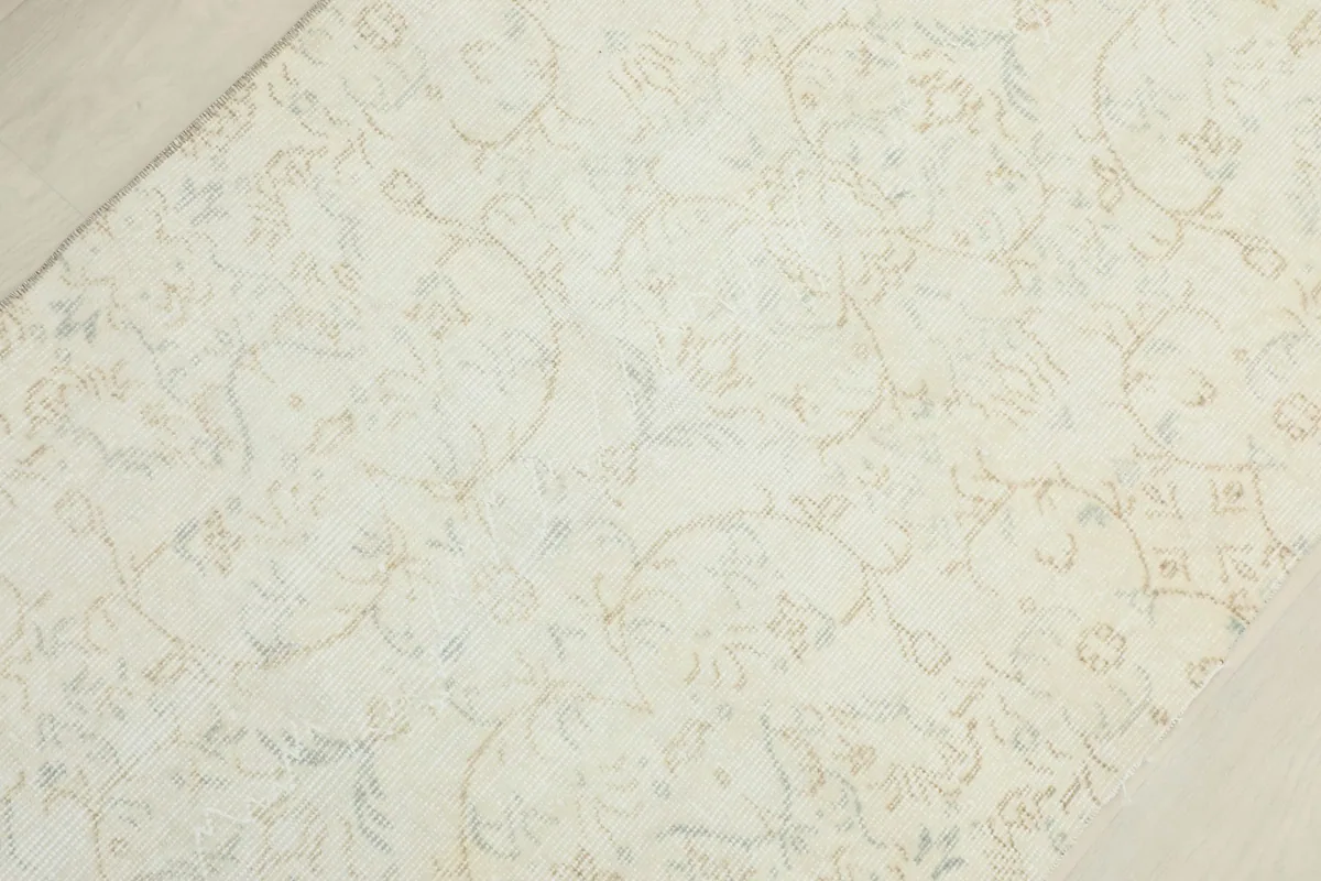 Overhead view focusing on the central part of the cream runner and its detailed floral design.