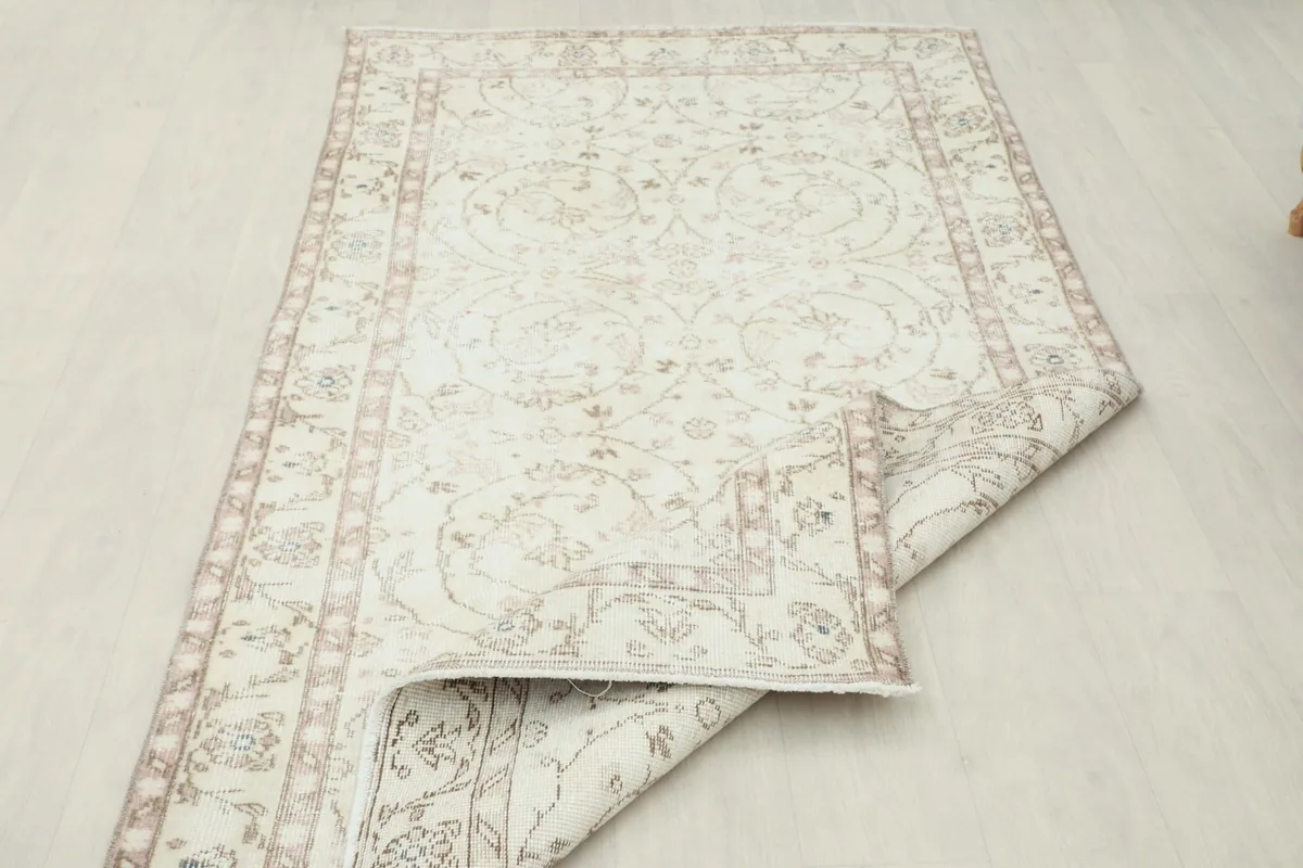 Side view of the rug with a corner folded, showcasing the thickness and back of the rug