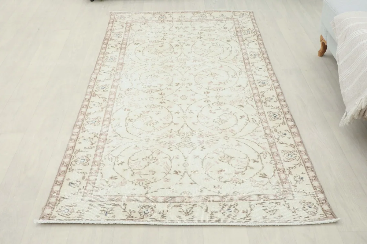 Full overhead view of the 3'7" x 6'9" vintage Anatolian rug with a corner slightly lifted