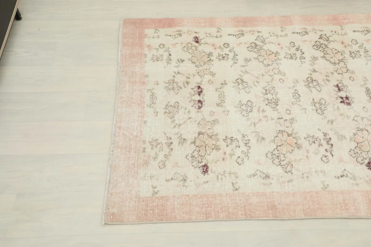 Overhead angle shot showcasing the rug's floral motifs and soft color transitions