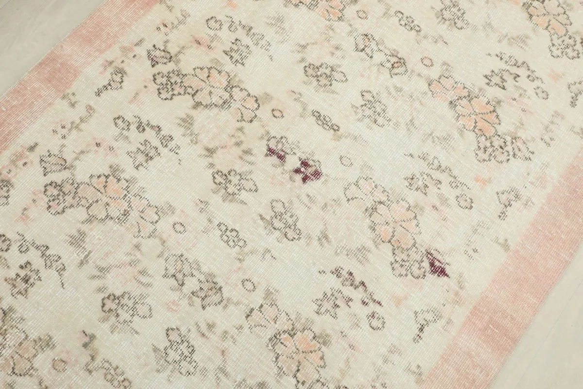 Detailed view of the central floral patterns and subtle color variations in the rug's pile