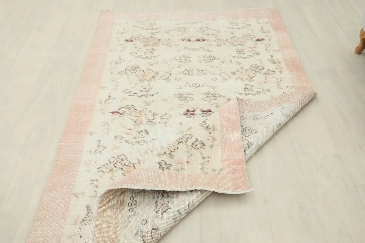 Partial view of the rug's back, indicating the hand-knotted construction
