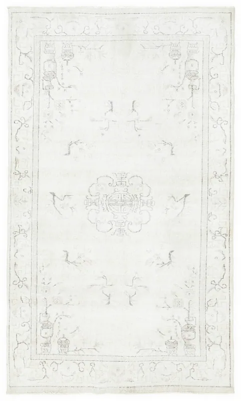 Full overhead view of the 4'11" x 8'3" ivory vintage Anatolian area rug with central medallion.