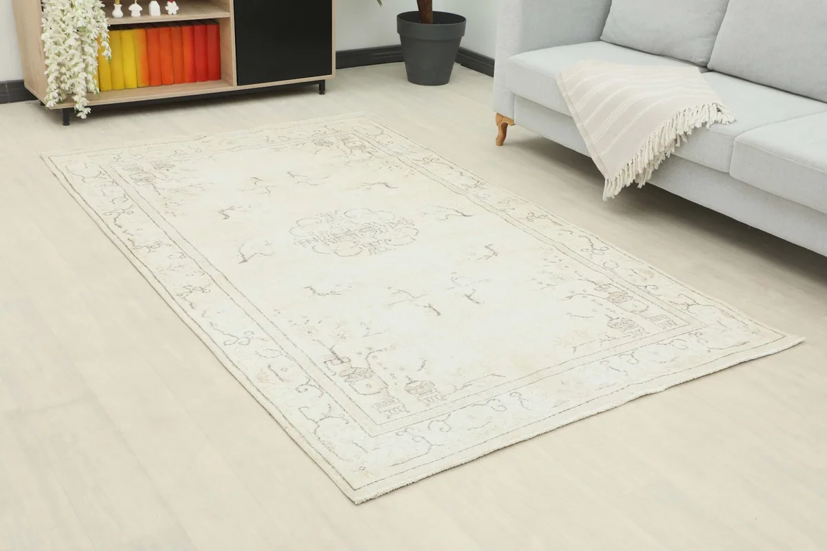 Angle view of the ivory vintage rug on a light floor, enhancing a modern living space.