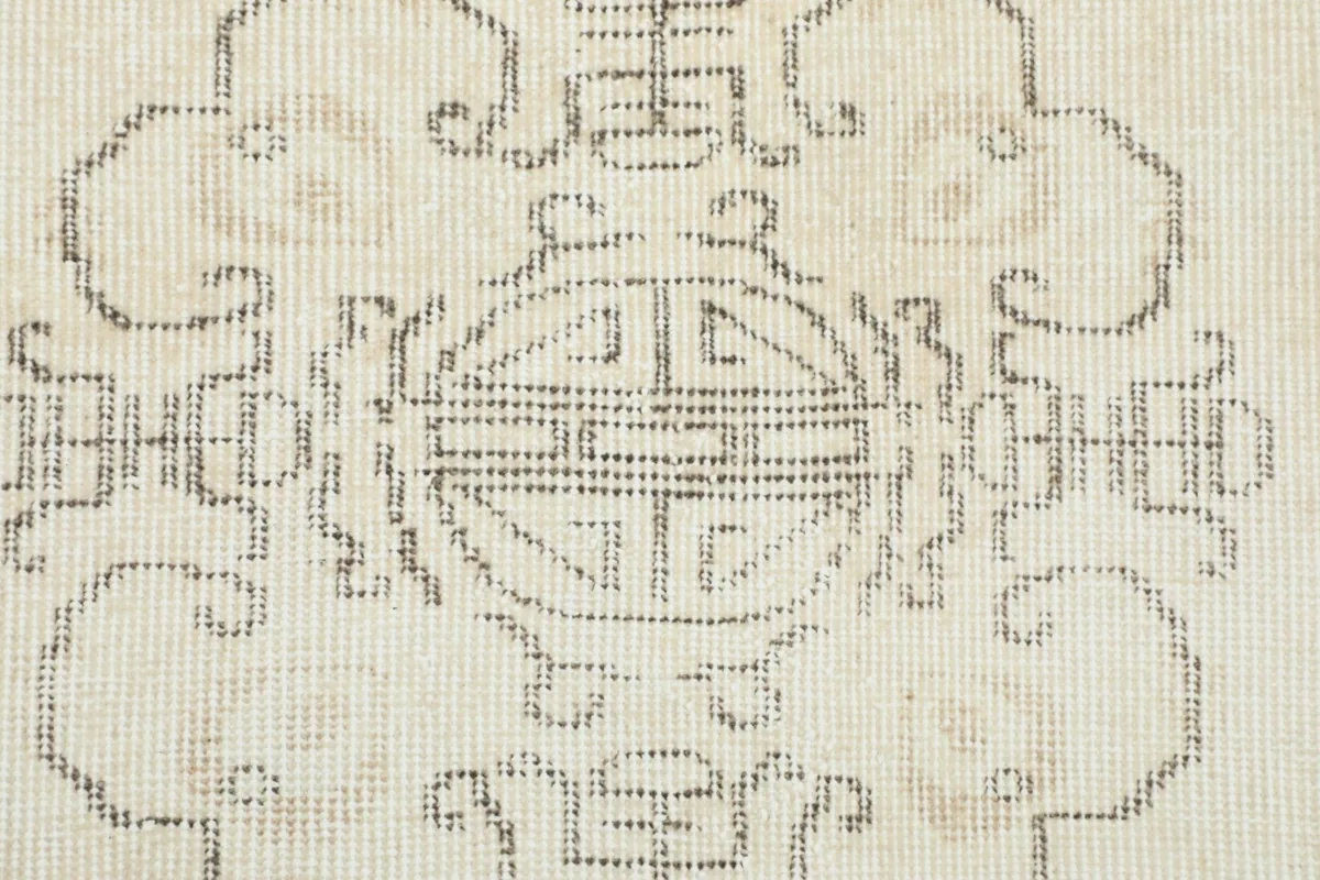 Close-up of the hand-knotted texture and detailed gray patterns within the central medallion.