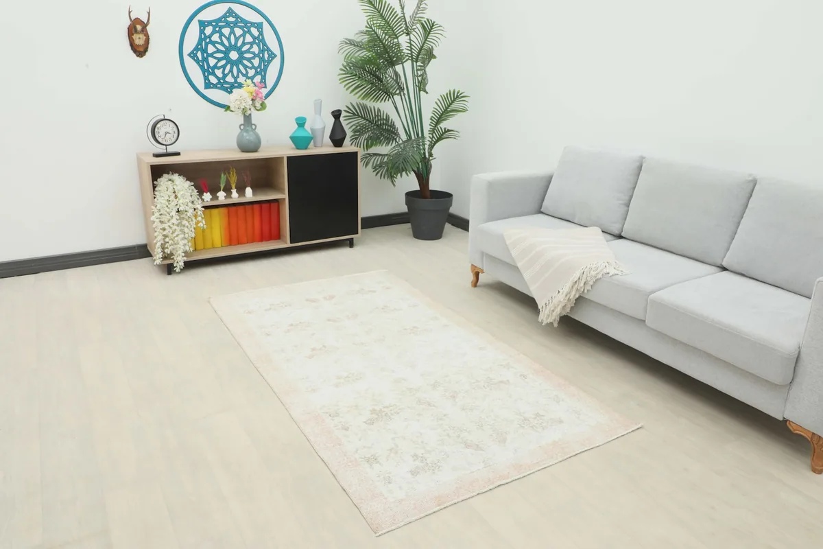 Vintage cream and beige floral rug displayed in a modern living room setting