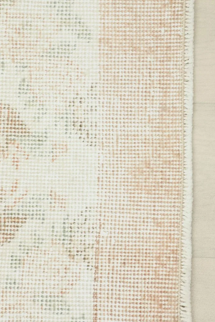 Close-up of the back of the rug, showing the cotton foundation and fine hand-knotting