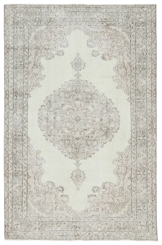 Full overhead view of the vintage ivory and beige medallion area rug on a white background.