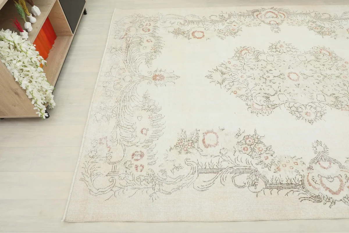 Detailed angle view of the rug's pattern and subtle color variations on the ivory field.
