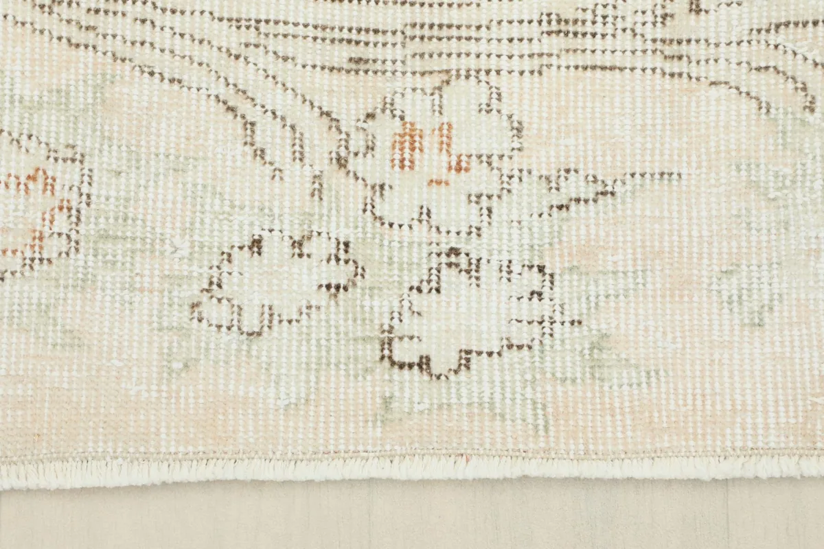 Close-up of the low wool pile and the texture of the vintage rug's surface.