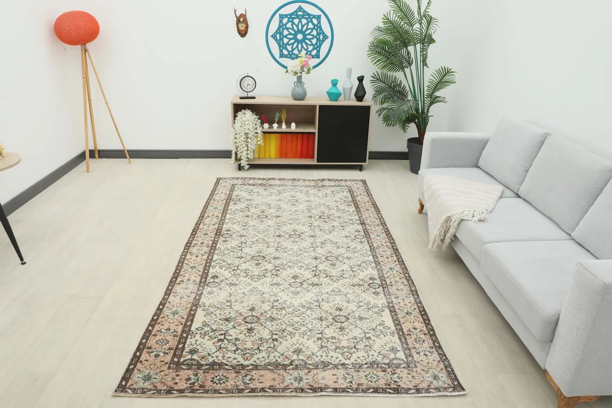 Full room view of the ivory and rose floral rug enhancing the living space