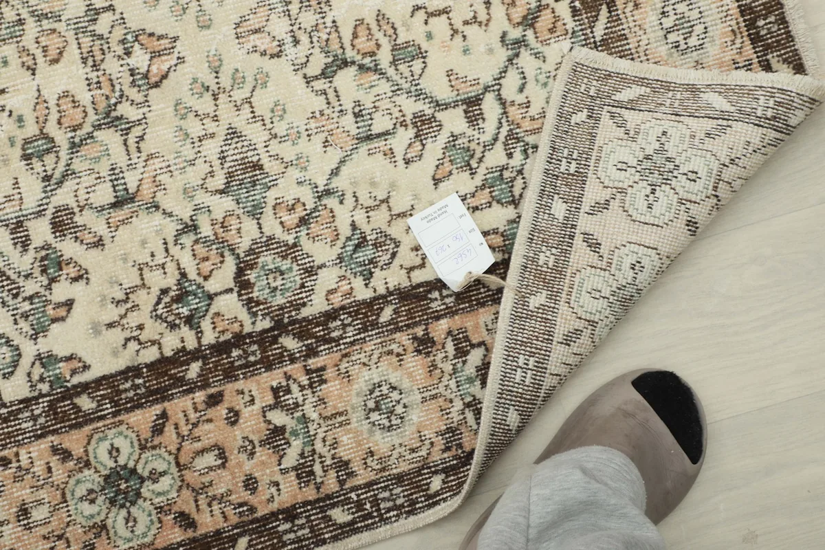 Backside of the rug showing the hand-knotted cotton foundation and wool pile