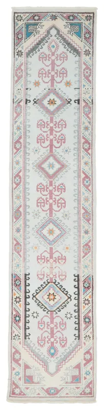 Full overhead view of the 2'7" x 11'9" vintage Anatolian runner with ivory, rose, and blue geometric patterns.