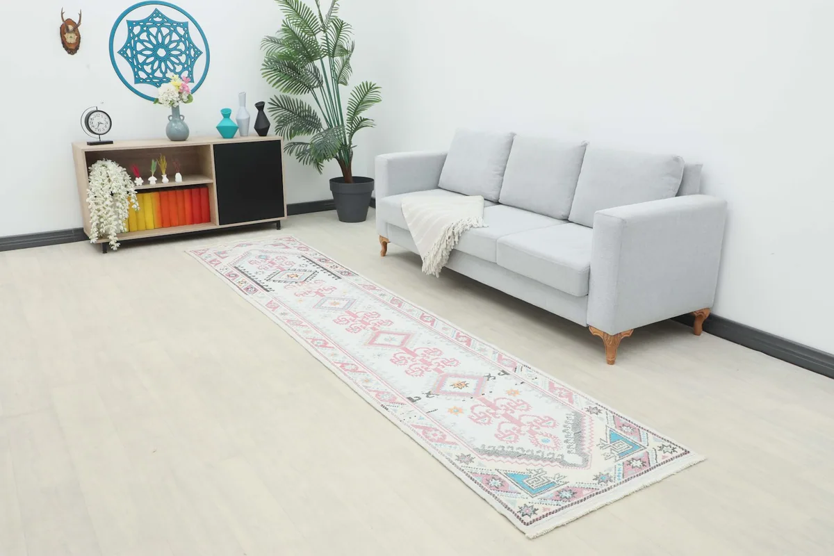 Long view of the vintage runner in a room setting, extending from a couch towards a console table.