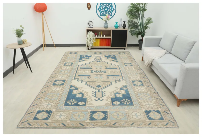 Full overhead view of the 7x11 vintage Anatolian area rug with cream, blue, and tan geometric patterns.