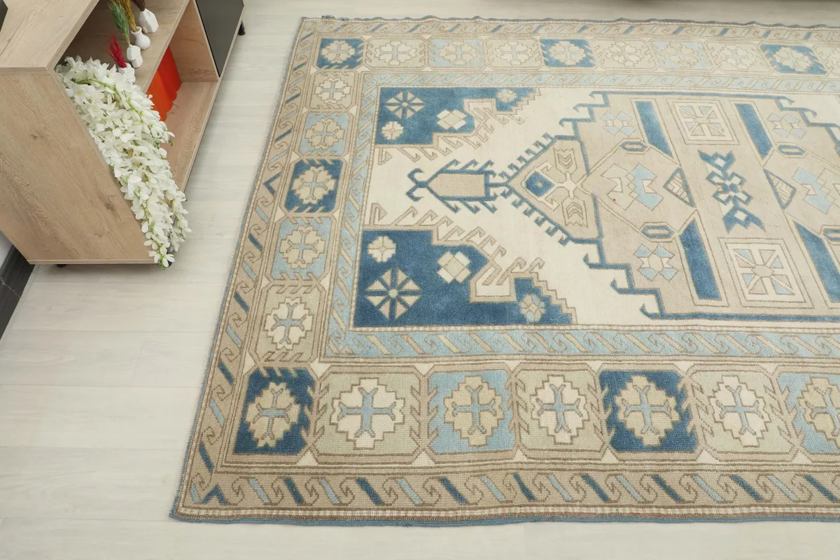 Detailed angle view of the rug's side, showing the intricate tribal motifs and color variations.