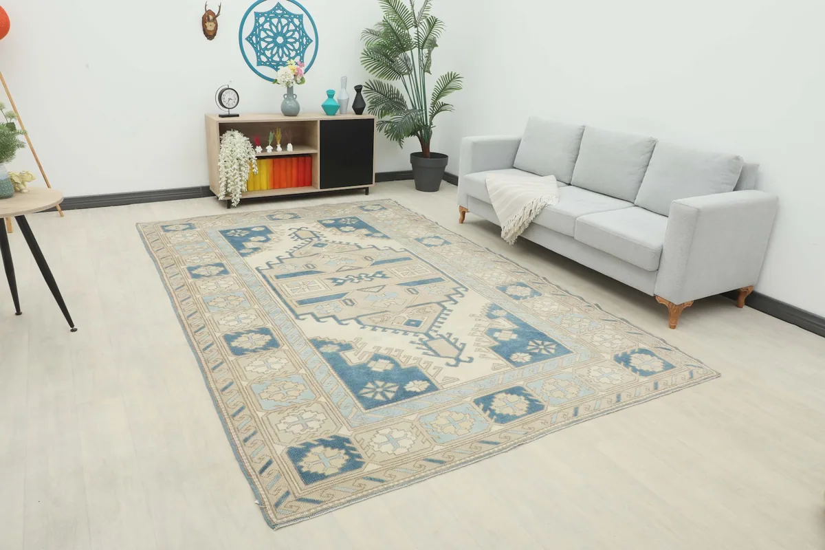 Vintage rug with cream and blue design in a modern living room setting.