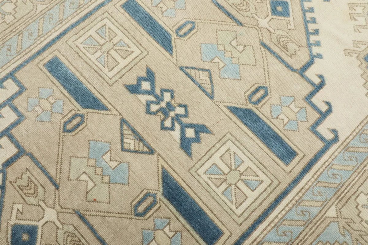Close-up detail of the rug's central medallion and surrounding geometric elements.