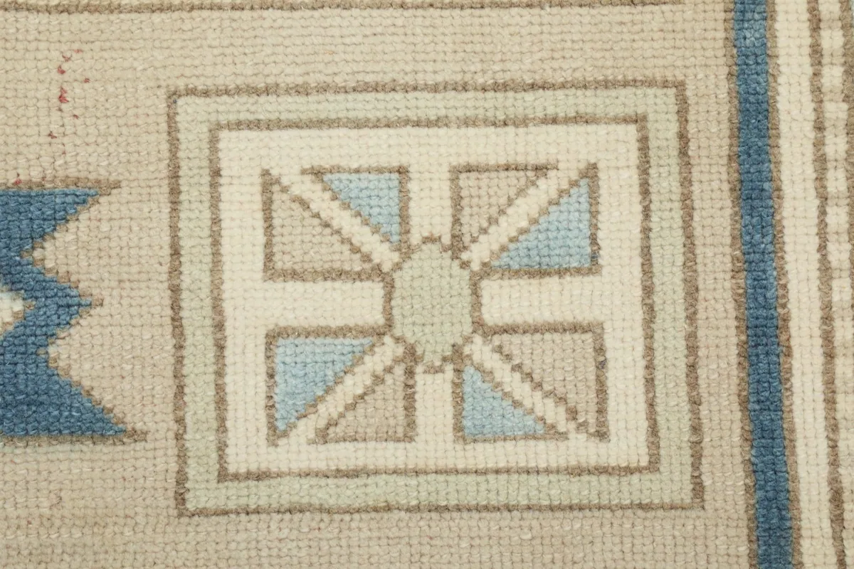 Extreme close-up of a square motif within the rug's border, showing knot detail.