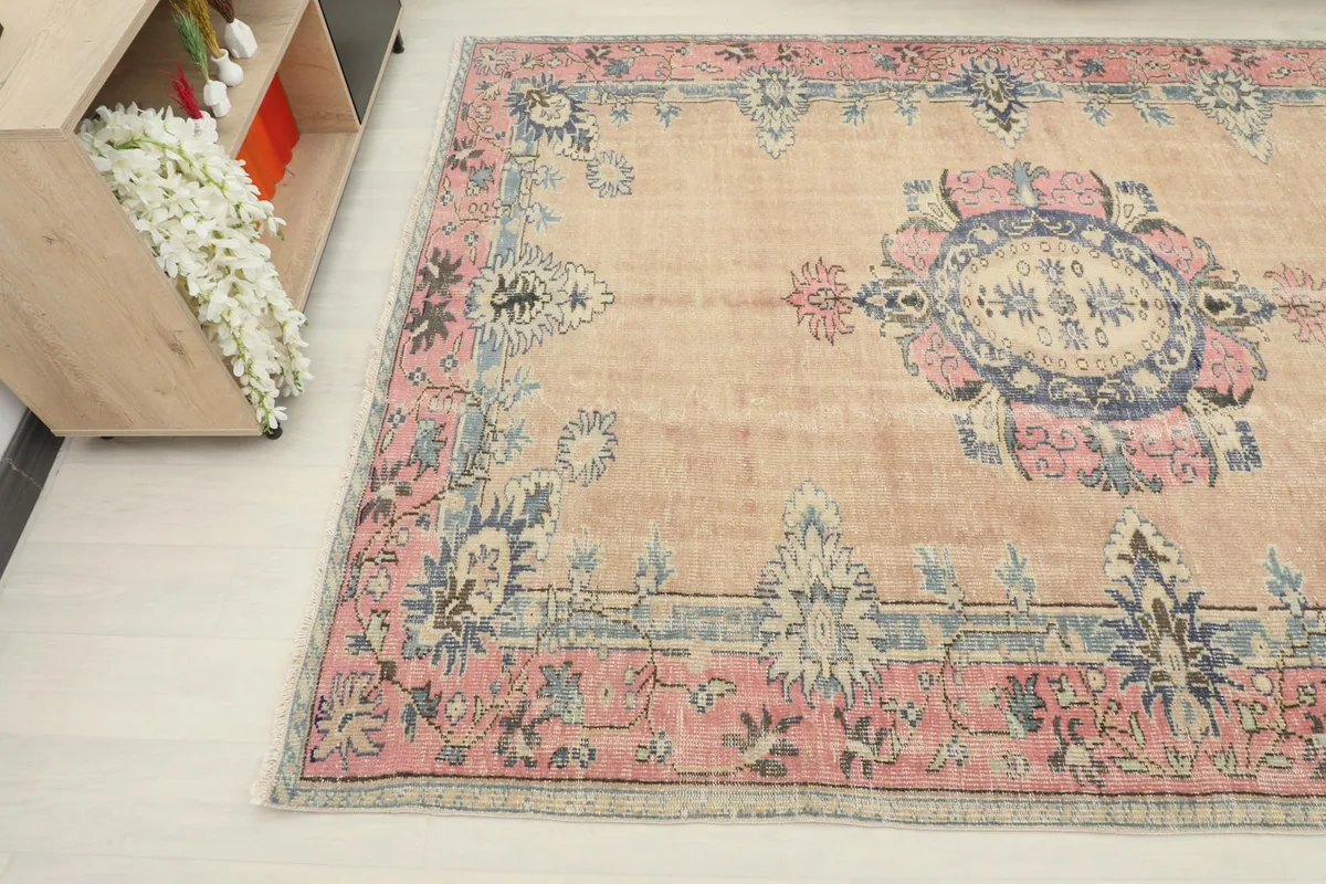 Detail view of the vintage rug's patterns and colors from an overhead angle