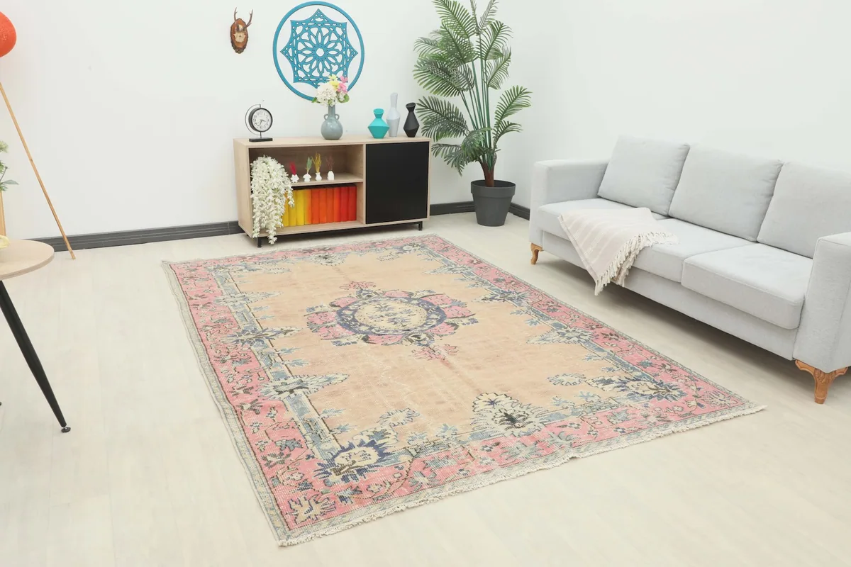 Vintage Anatolian rug displayed in a living room setting with a light gray couch
