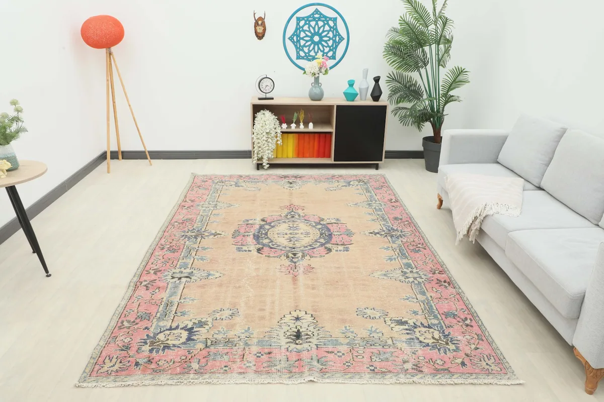 Full room view of the beige, rose, and navy vintage Anatolian rug complementing the decor