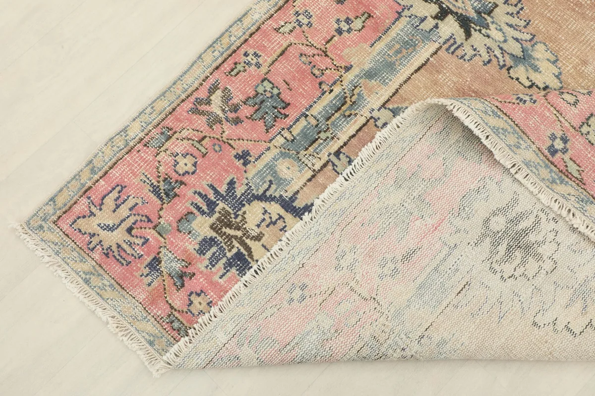 View of the rug's backside and construction, showing its hand-knotted nature
