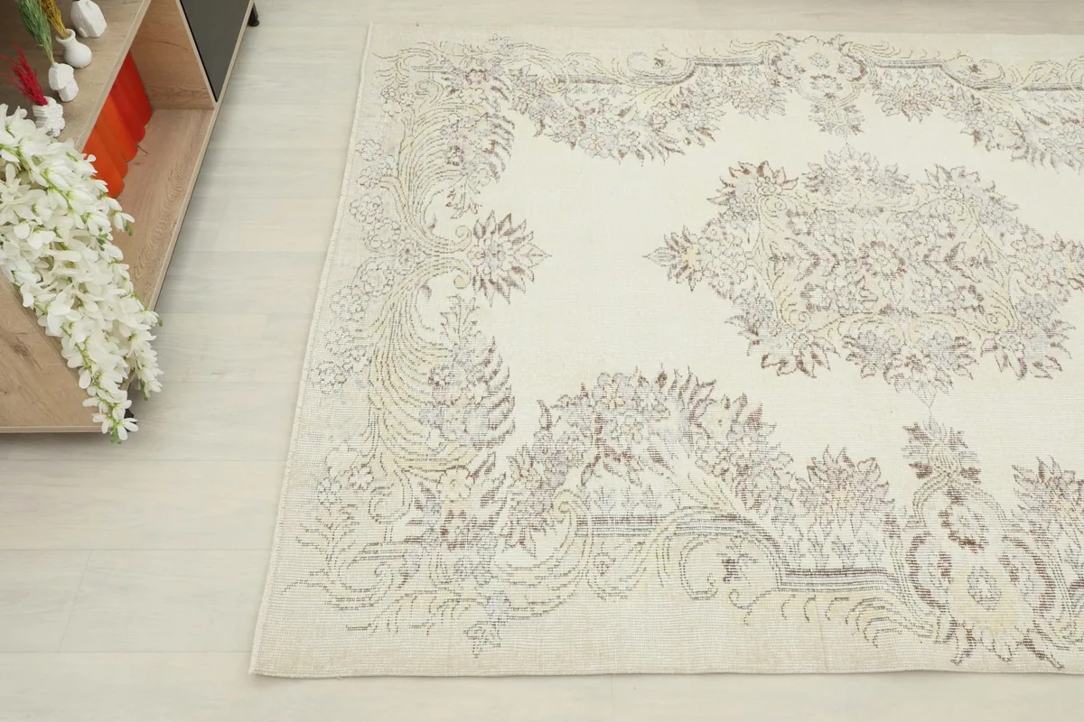 Another close-up angle of the ivory and gray rug, showing the blend of colors and faded motifs