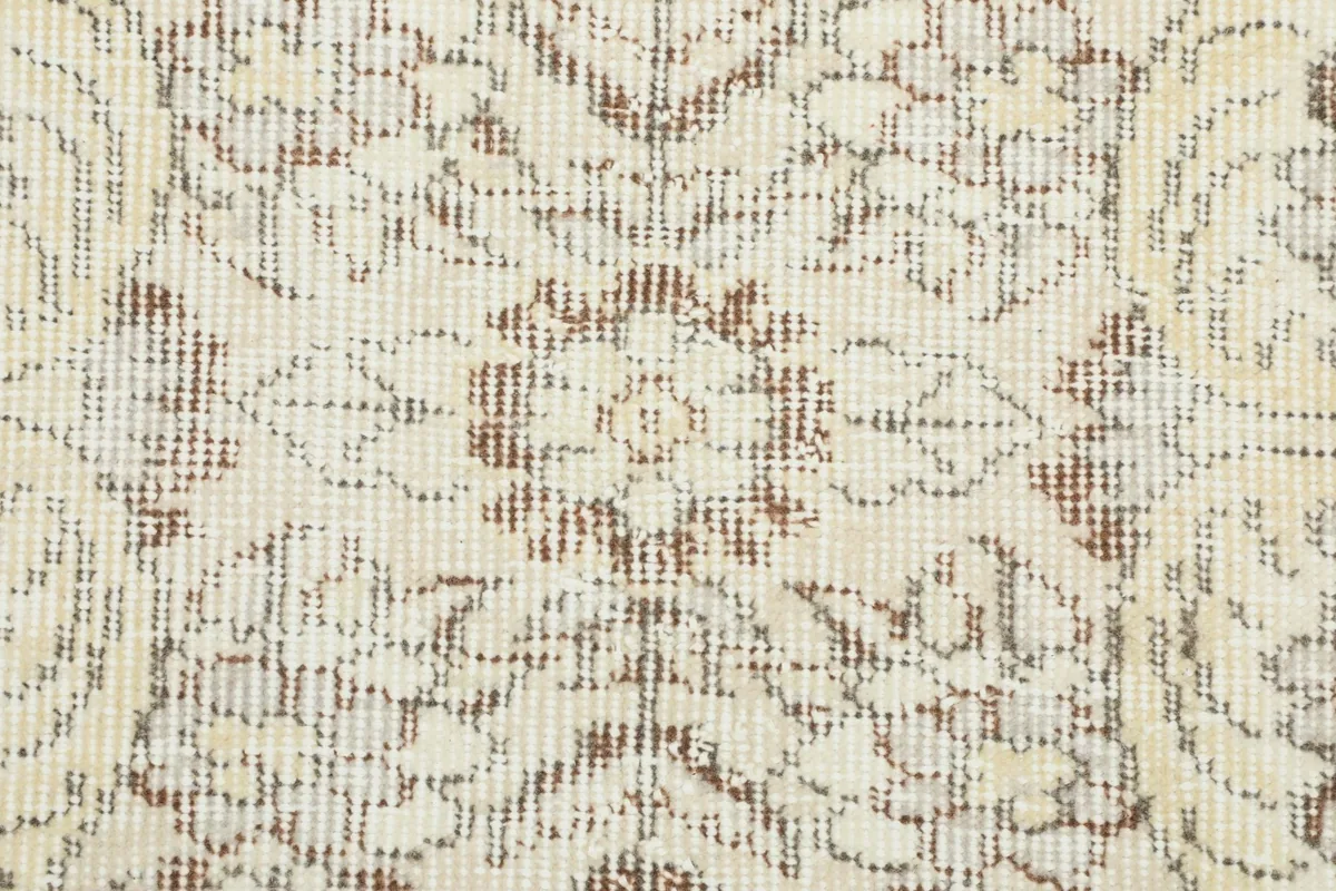 Close-up of the low pile and intricate knotting, revealing subtle color variations in the wool