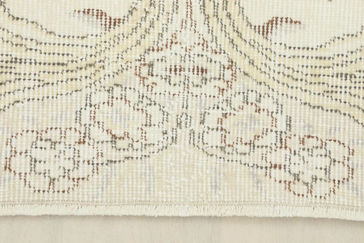 Detail showing the edge of the rug with its short, natural cotton fringe and distressed pattern
