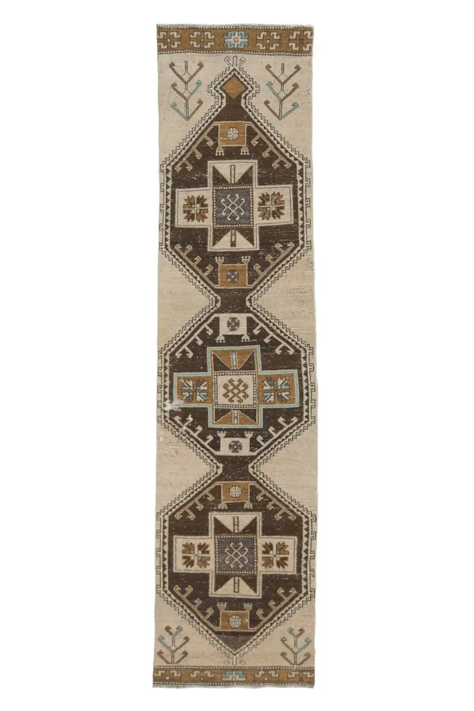Overhead view of the entire 2'8" x 10'11" vintage Anatolian runner rug on a white background.