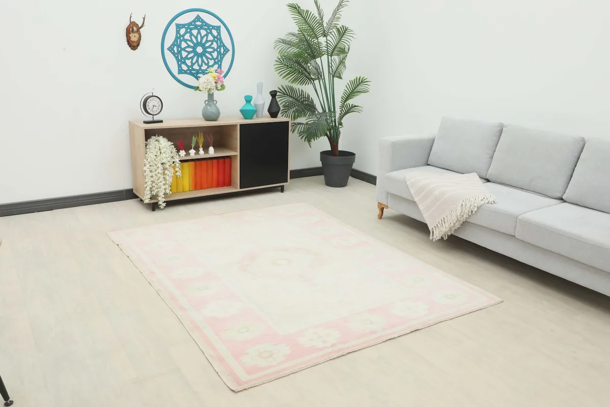 Vintage Anatolian rug displayed in a bright living room setting with a gray sofa