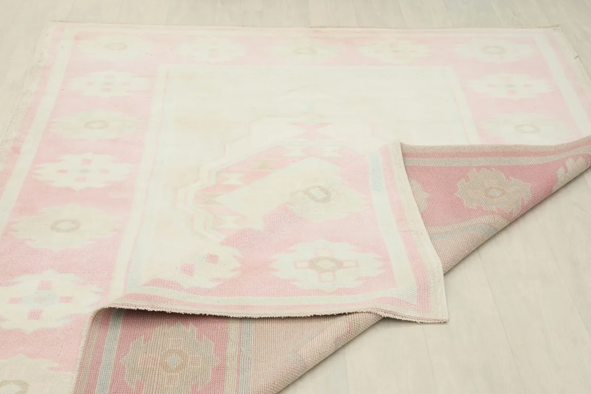 Partial view of the rug folded back, showing the consistent color and weave from front to back
