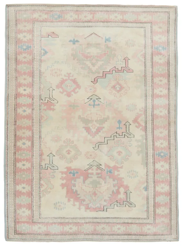 Full top view of the 5'5" x 7'4" cream and pink vintage Anatolian rug with geometric patterns on a white background.