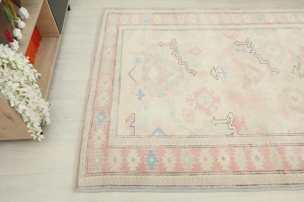 Angled view of the rug's surface, capturing the soft color variations and the hand-knotted texture.