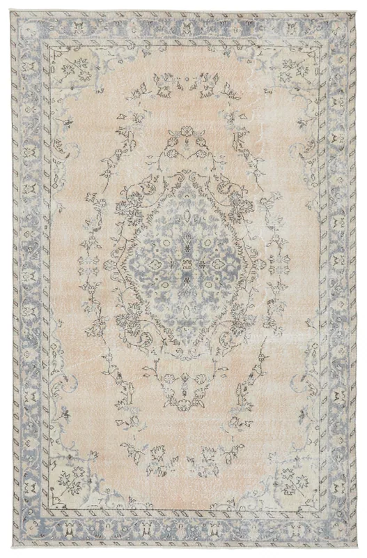 Full top view of the beige and blue vintage Anatolian area rug on a white background.