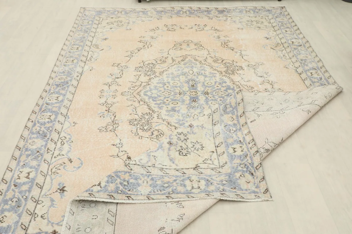 Rug partially folded, displaying both the front design and the reverse side.