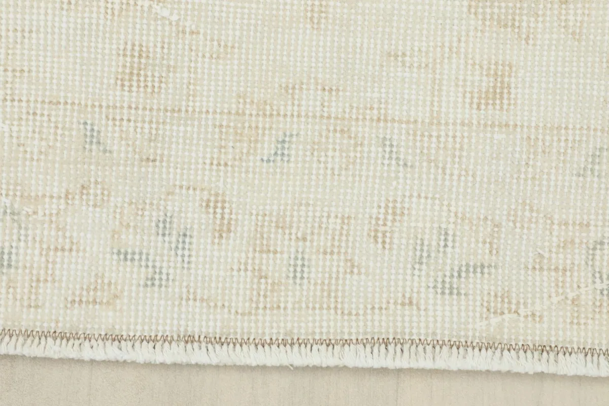 Close-up of the rug's border and fringe, displaying the intricate weaving