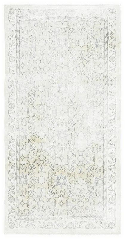 Full overhead view of the beige and gray vintage Anatolian rug on a white background