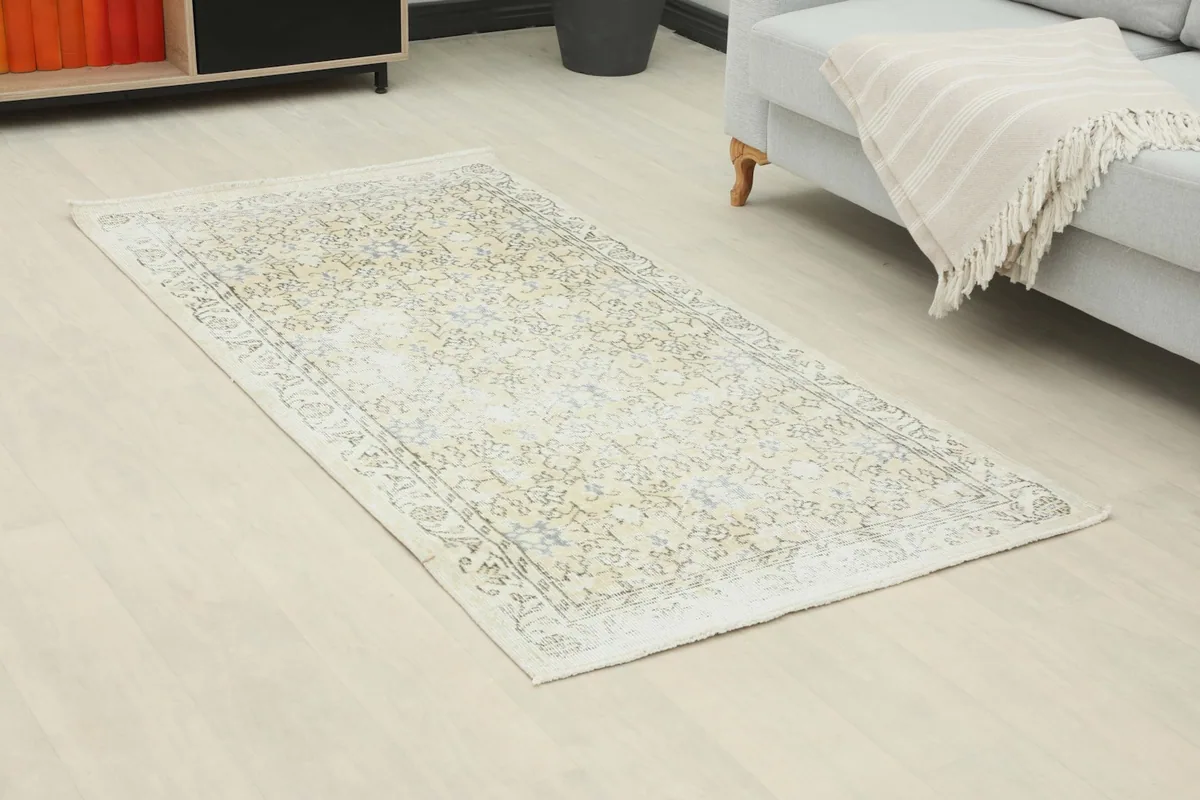 Angled view of the beige and gray rug in a living room, showing its placement